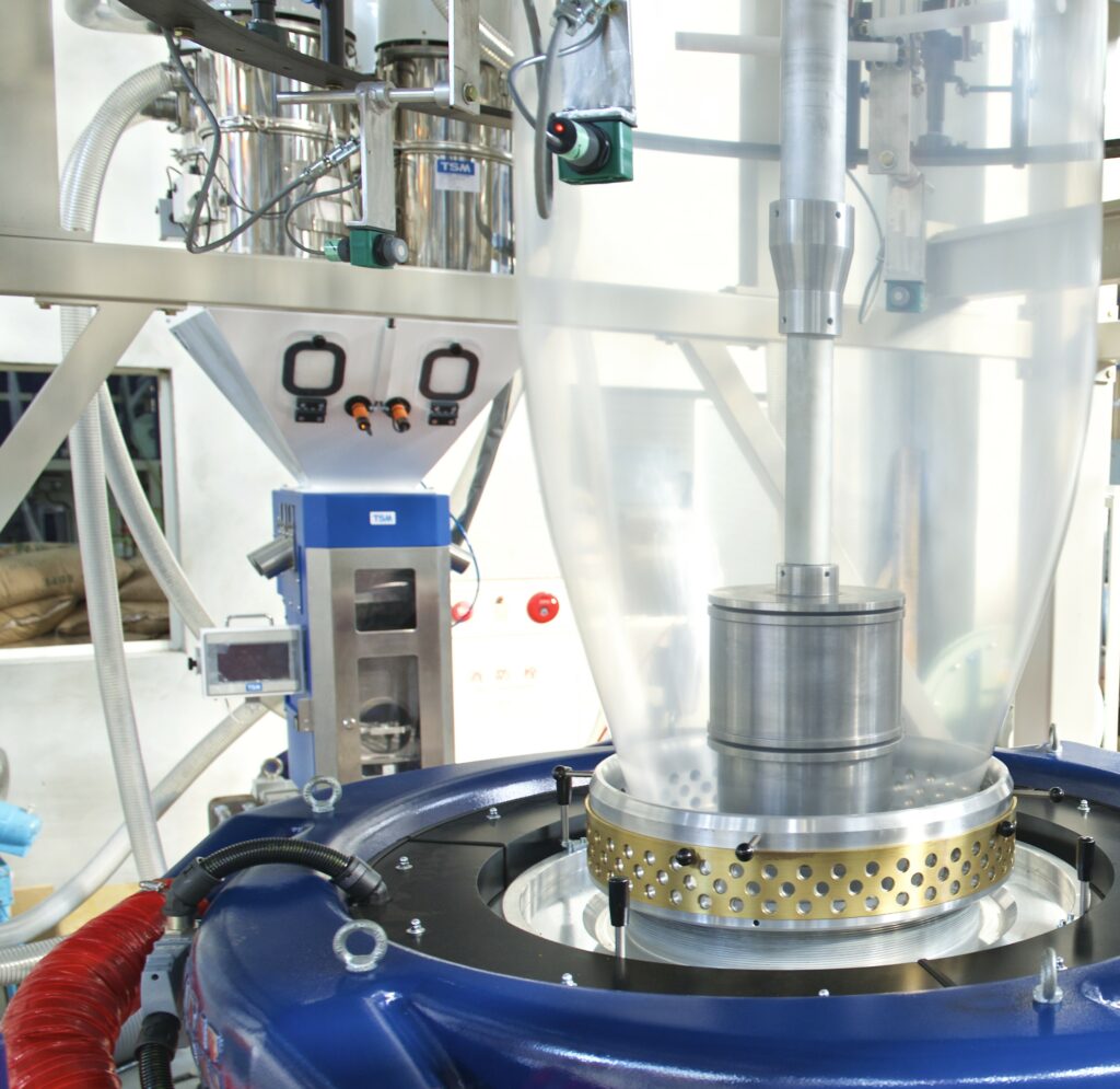 Blown film extrusion machine showing plastic bubble formation in packaging factory